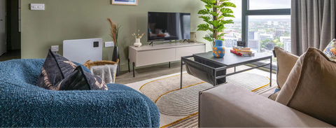 furnished apartment living room with sofa, chair, coffee table, tv and tv unit with accessories