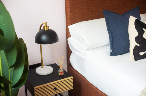 Bedroom with a bed, nightstand, and decorative items.