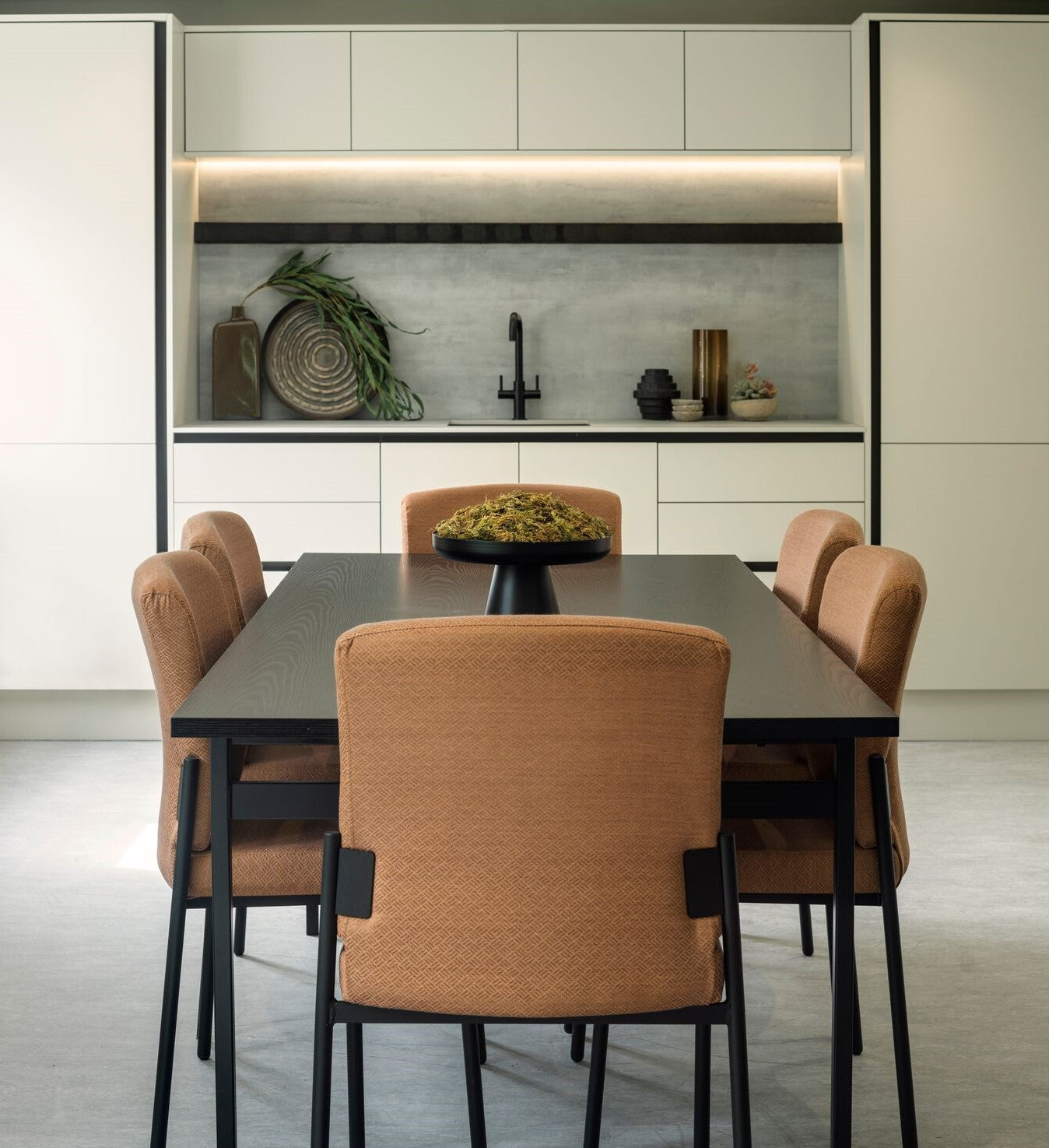 Dining area with a table and chairs in a modern kitchen setting