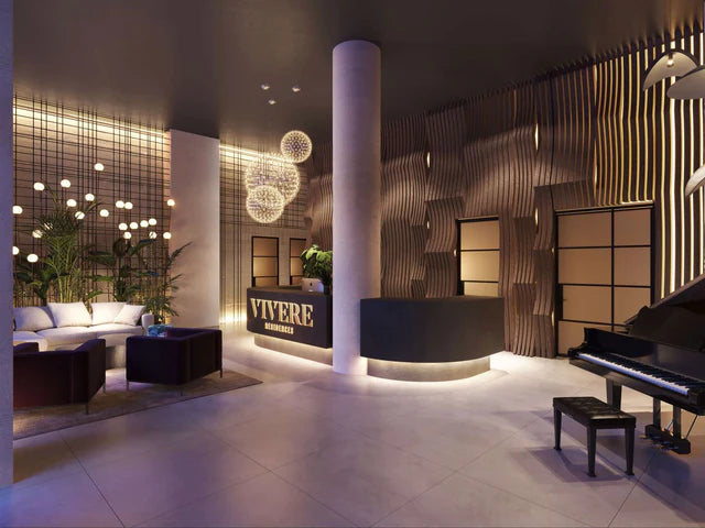 darkly lit lobby with tables, chairs, and reception desk