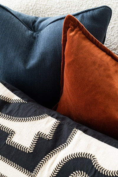 close up of blue and orange pillows