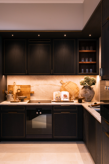 kitchen with dark cabinets, down lighting, oven and kitchen accessories