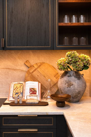dark kitchen with white marble worktops and accessories